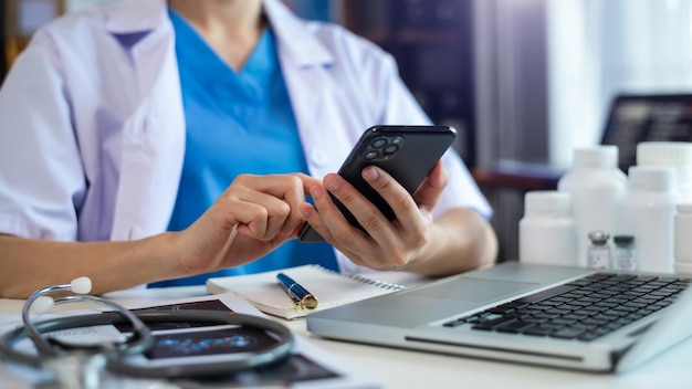 Cropped shot of young female doctor summarises patient charts with digital tablet in her roomxA