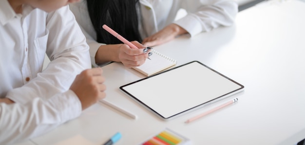 Cropped shot of young hard-working designer working on their concepts together with mock-up tablet