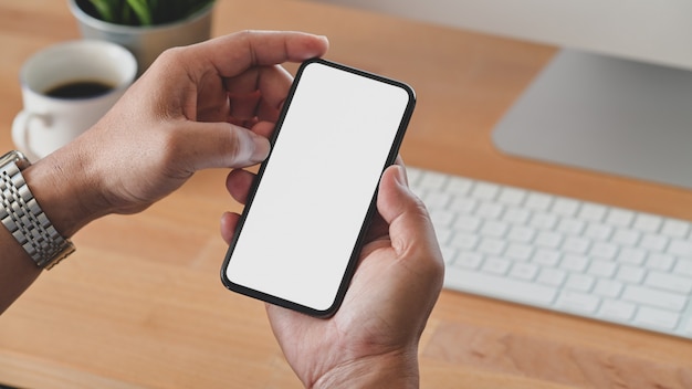 Cropped shot of young man holding blank screen 