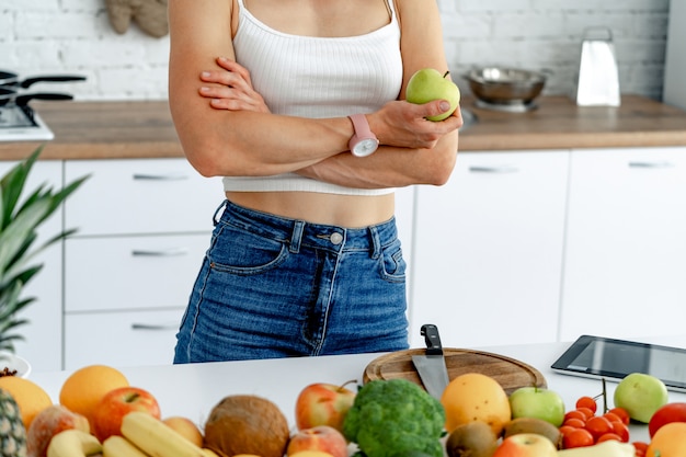 Cropped shot of young woman eating fruit for breakfast