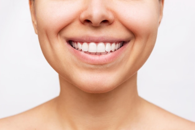 Cropped shot of a young woman with perfect white even teeth Closeup of beautiful smile Dentistry