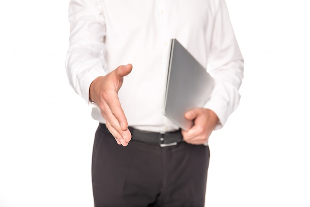 cropped view of businessman with laptop giving hand isolated on white