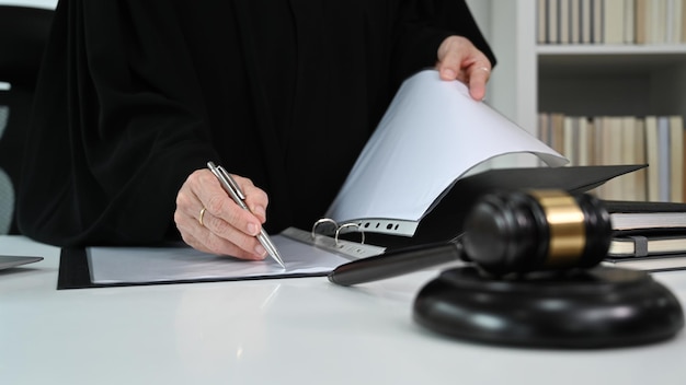 Cropped view of female lawyer working with contract or agreement document to customer for signing Law and justice concept