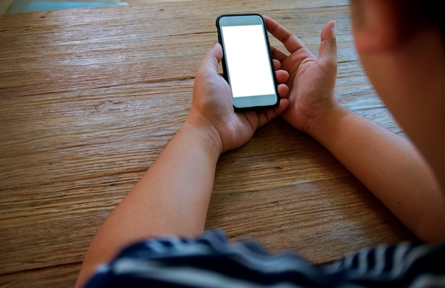 Cropped view of male hands holding cell phone with blank screen.Man using electronic gadget, typing message or checking newsfeed on social networks.