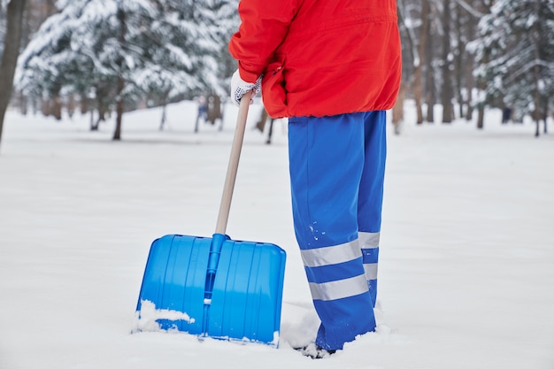 Cropped view of male janitor in process of working in winter