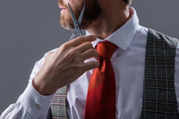 Cropped view of man cut hair with hairdressing scissors man barbering in hairdressing studio