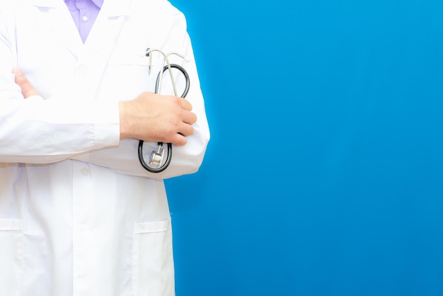 Cropped view of Man Doctor in uniform standing and holding a stethoscope Copy space for your text