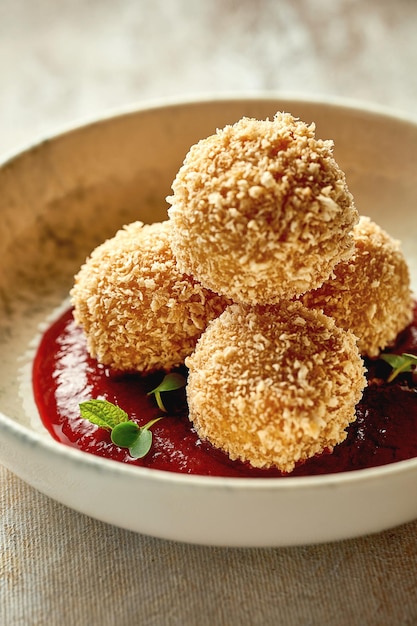 Croquette with cheese in cranberry sauce Closeup selective focus