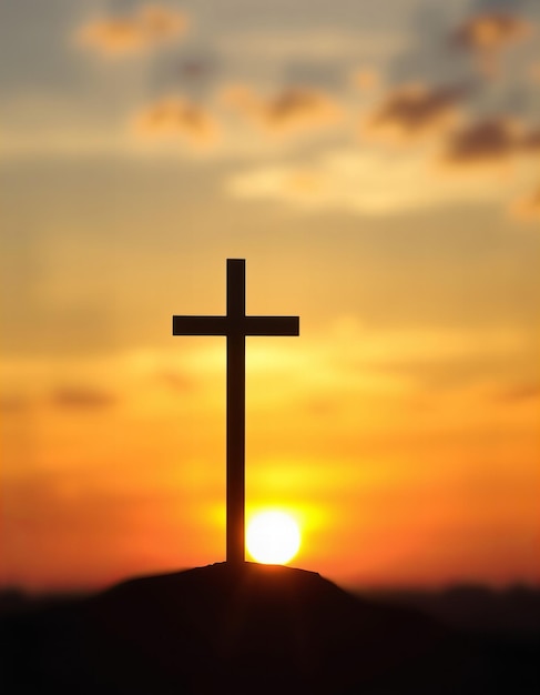 a cross is in front of a sunset sky