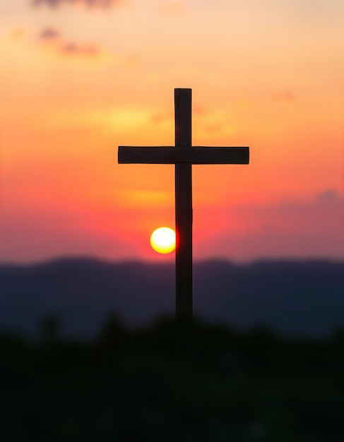 a cross is silhouetted against a sunset sky