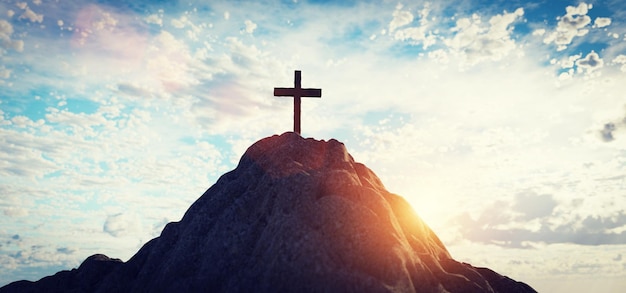 Cross on mountain peak at sunset christian religion