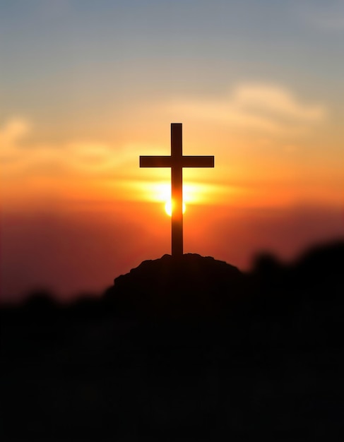 a cross with the sun setting behind it