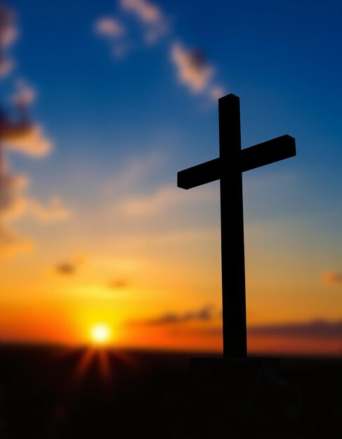 a cross with the sun setting behind it