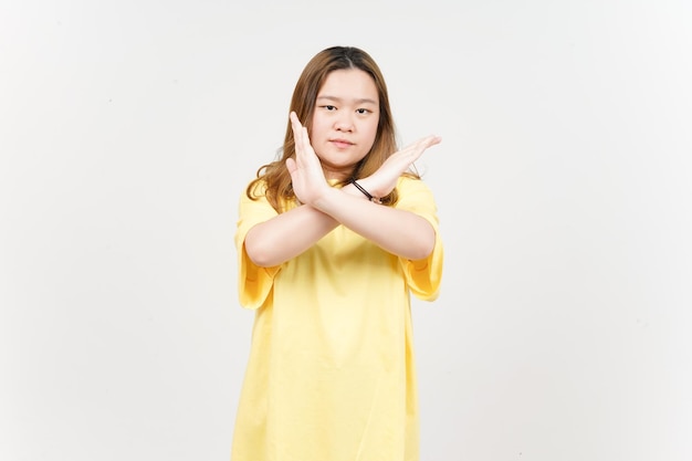 Crossed hand rejection sign of Beautiful Asian Woman wearing yellow TShirt Isolated On White