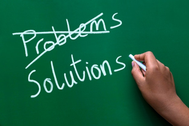 Crossing out problems and writing solutions on a blackboard