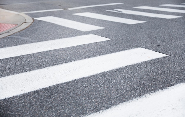 A crosswalk with a white stripe on the road.