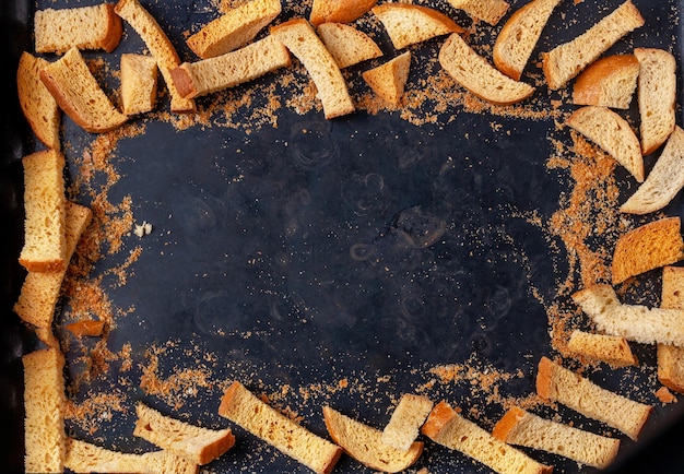 Croutons with crumbs lie on a castiron pan copy space