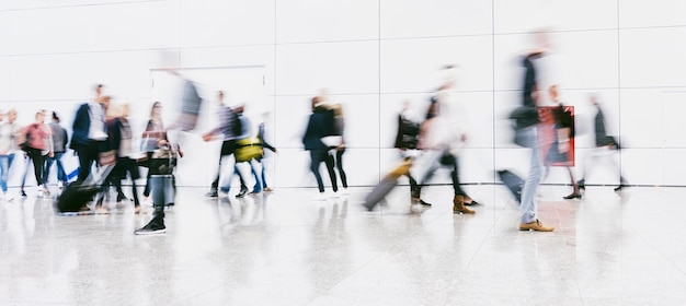 crowd of anonymous blurred people walking in a airport. ideal for websites and magazines layouts