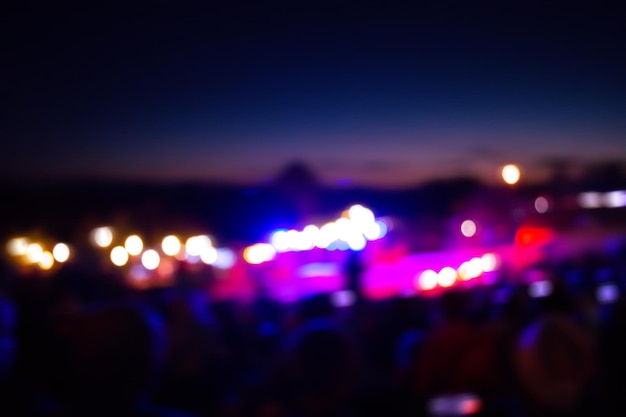 Crowd enjoying the music night festival Joyful musicians and crowd of fans outdoors at night