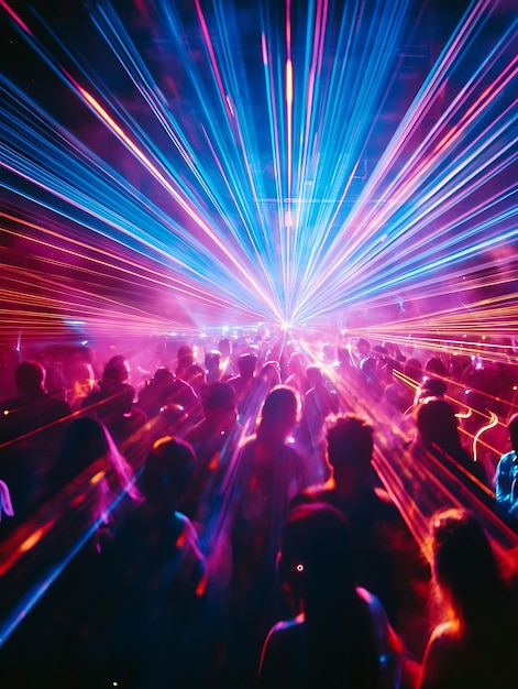 a crowd of people are standing in a room with a colorful light