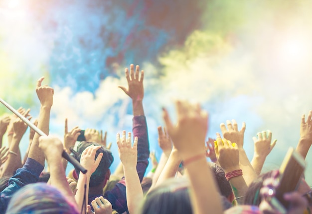 Crowd of people dancing and celebrating Holi festival of colors