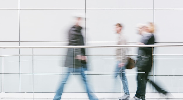 crowd of people walking in a modern hall. ideal for websites and magazines layouts