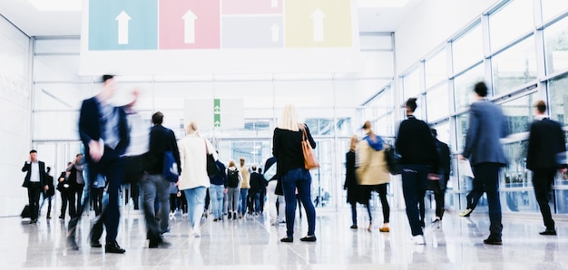 crowd of trade show visitors rushing at a entrance. ideal for websites and magazines layouts