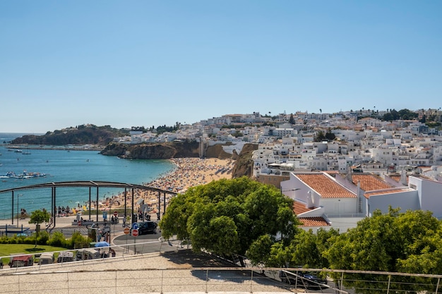 Crowded beach in the hot summer in the city of Albufeira