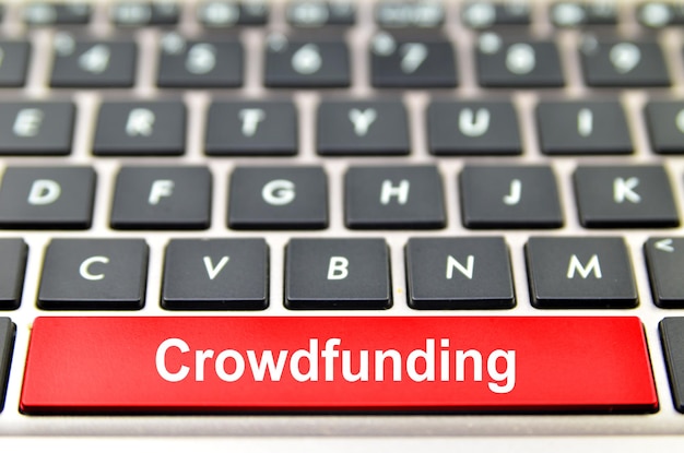 Crowdfunding word on computer space bar