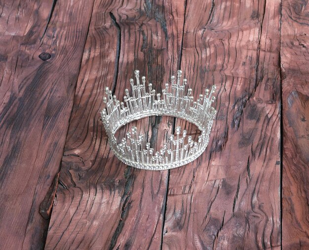 crown with diamonds on wooden background