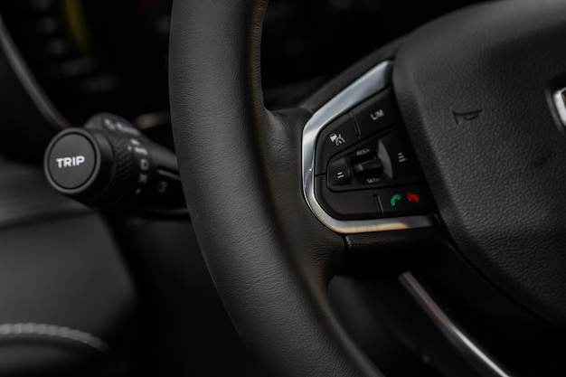 Cruise control switch closeup. Adaptive cruise control leaver. Cruise control on steering wheel.