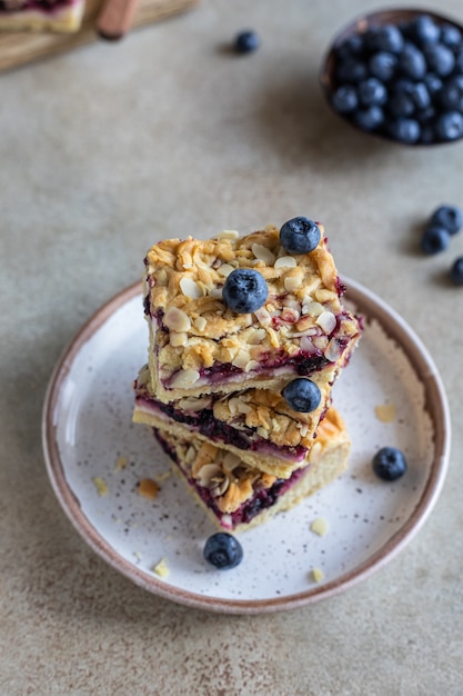 Crumble cheesecake bars with blueberry filling and fresh blueberries