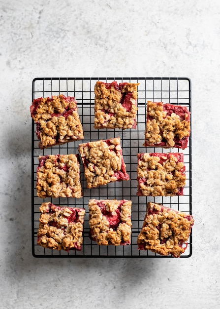 Crumble oatmeal strawberry bars on the baking cooling rack top view flat lay