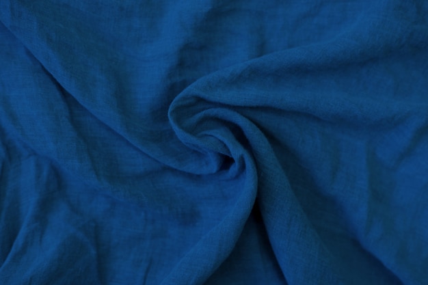 Crumpled blue fabric texture close up.