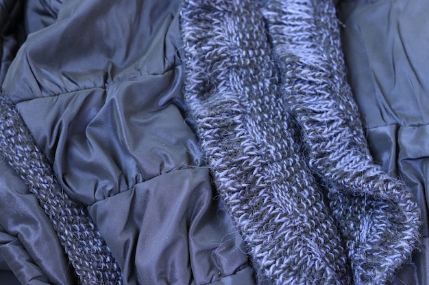 crumpled blue metallic fabric with knitted elements background