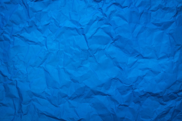 Crumpled of blue paper sheet texture background.