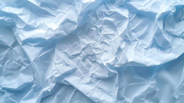 Crumpled blue paper with light reflections creating texture and depth