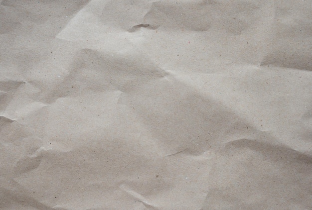 Crumpled brown kraft paper texture background of paperboard sheet