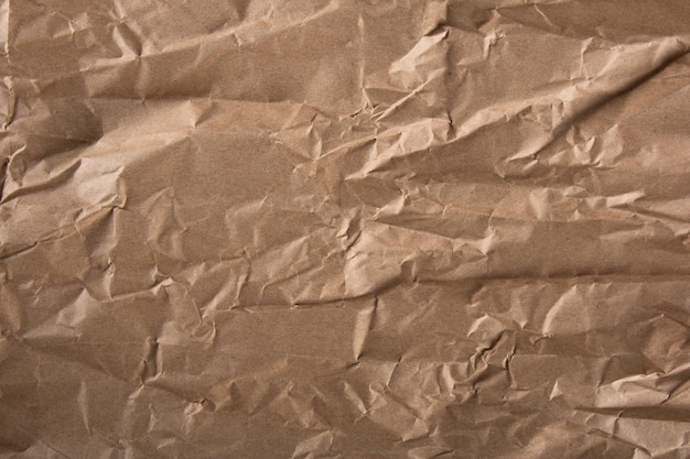 Crumpled brown paper texture wavy textured background