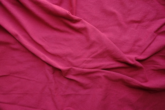 Crumpled fabric texture in maroon color