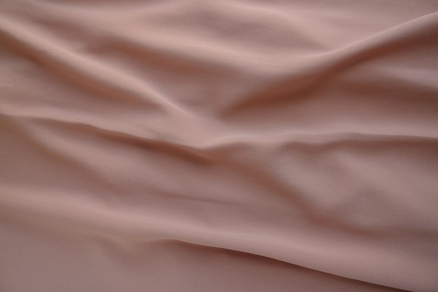 Crumpled fabric texture in tan gray color