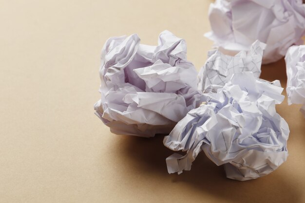 Crumpled paper balls on a colored background close-up.