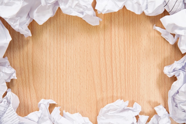 Crumpled paper balls on wooden background.