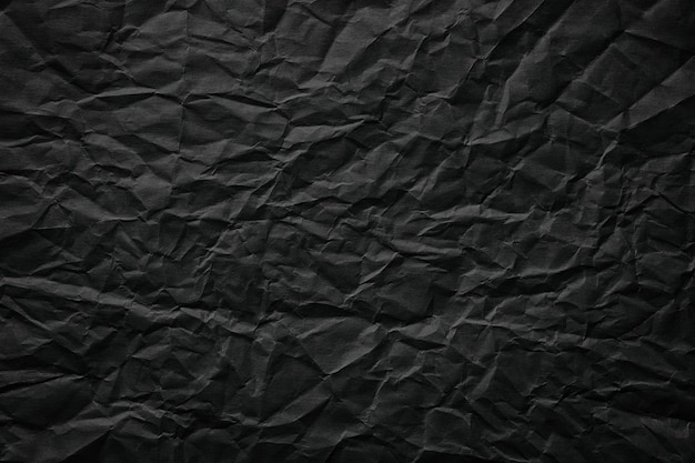 Crumpled paper texture black cardboard sheet gloomy background