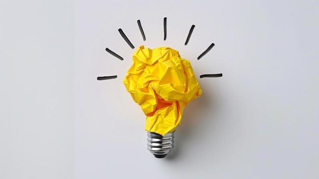 Photo a crumpled piece of yellow paper forms the shape of a lightbulb against a white background symbolizing a bright idea or creative concept