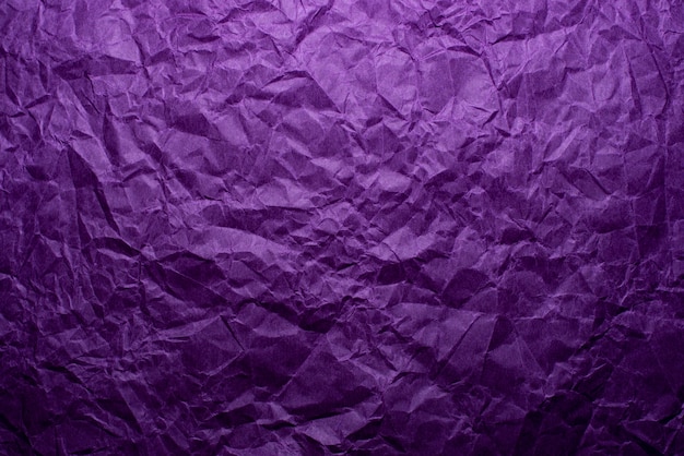 Crumpled purple paper texture background