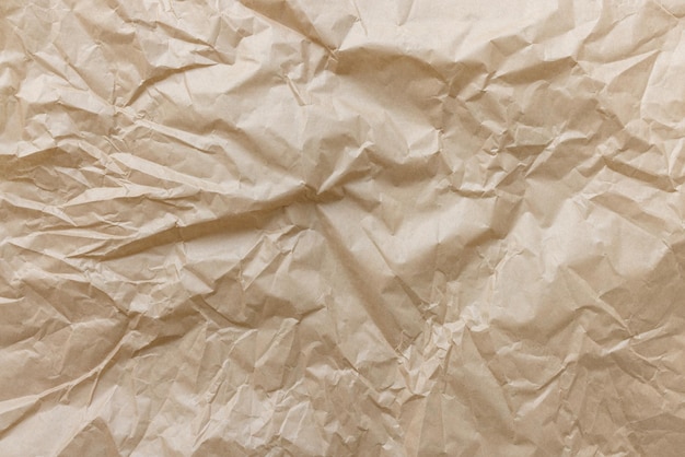 Crumpled used brown wrapping paper texture background