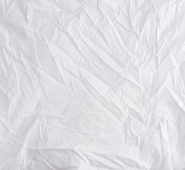 Crumpled white cotton fabric, fabric for sewing clothes and shirts