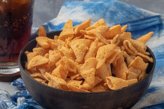 Crunchy corn cones snack on wooden bowl