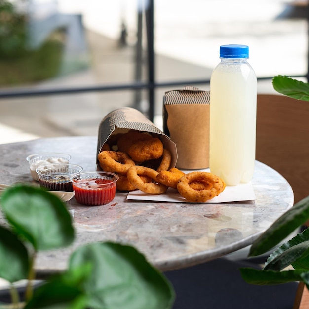 Crunchy deep fried squid or onion rings in batter set on gray stone table background Co